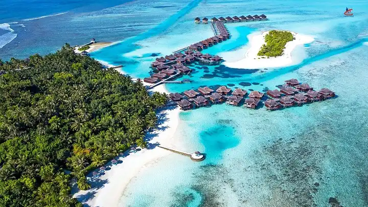 Romantic couple enjoying sunset in overwater villa in Maldives