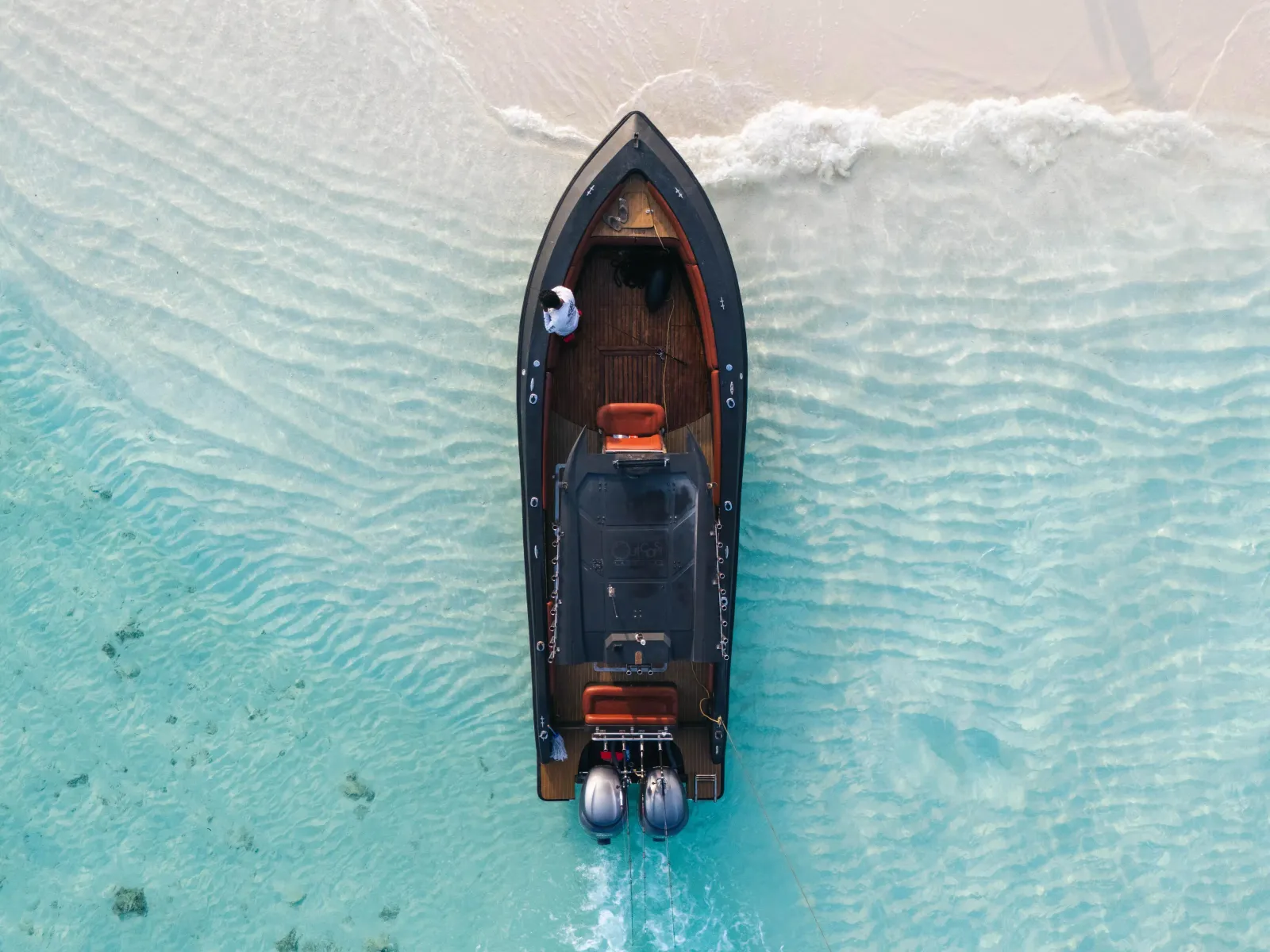 Aerial view of a speedboat over a white sand flat